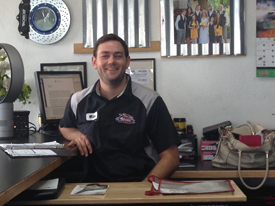 Staff member at desk inside Red Mountain Tire in Mesa, AZ