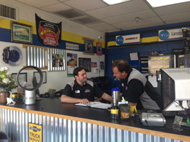 Staff members conversing at front desk inside Red Mountain Tire