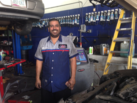Red Mountain Tire service technician smiling